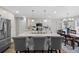 Large kitchen island with seating, white cabinets, and granite countertops at 13735 Steele Ct, Thornton, CO 80602