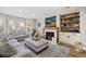 Spacious living room with a fireplace and built-in shelving at 13735 Steele Ct, Thornton, CO 80602