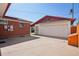 Detached garage and brick home are set in a sunny backyard setting at 11349 Downing Dr, Northglenn, CO 80233