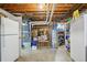 Unfinished basement with exposed ceiling, appliances, and mechanical equipment visible at 11349 Downing Dr, Northglenn, CO 80233