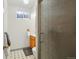 Bathroom featuring tiled floors, a wooden vanity, and a shower with textured glass at 11349 Downing Dr, Northglenn, CO 80233