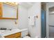 Cozy bathroom with wood-trimmed mirror, towel rack, toilet, and walk-in shower at 11349 Downing Dr, Northglenn, CO 80233
