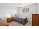 Serene bedroom with a twin bed, soft gray comforter, and a window with tree views at 11349 Downing Dr, Northglenn, CO 80233