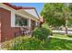 Inviting front porch with seating, surrounded by colorful flowers and well-manicured landscaping at 11349 Downing Dr, Northglenn, CO 80233