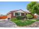 Charming red brick house with lush front lawn and a cozy fire pit feature at 11349 Downing Dr, Northglenn, CO 80233