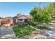 A well-maintained red brick house with lush greenery, mature trees, and inviting curb appeal at 11349 Downing Dr, Northglenn, CO 80233