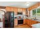 Bright kitchen with stainless steel appliances, wood cabinets, and a large window offering ample natural light at 11349 Downing Dr, Northglenn, CO 80233