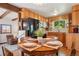 Warm kitchen featuring oak cabinets, modern appliances, and a charming dining area for cozy meals at 11349 Downing Dr, Northglenn, CO 80233