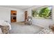 Comfortable living room with a view to the kitchen, cozy seating, and a large window at 11349 Downing Dr, Northglenn, CO 80233