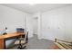 Well-lit home office featuring a desk and chair with an open door leading to another room at 11349 Downing Dr, Northglenn, CO 80233
