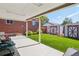 Covered patio with seating, a well-manicured lawn, and storage shed at 11349 Downing Dr, Northglenn, CO 80233