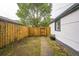 Private backyard with wood fence, gated entrance, and mature trees creating a serene outdoor space at 7010 W 44Th Ave, Wheat Ridge, CO 80033