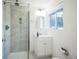 Bathroom featuring a glass shower, bright window, vanity, and a neutral color palette at 7010 W 44Th Ave, Wheat Ridge, CO 80033