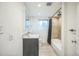 Modern bathroom features tiled shower over tub, stylish vanity, and ample lighting at 7010 W 44Th Ave, Wheat Ridge, CO 80033