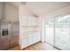 Modern kitchen with stainless steel refrigerator and sliding glass door at 7010 W 44Th Ave, Wheat Ridge, CO 80033