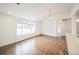 Inviting living room with hardwood floors, vaulted ceiling, and a large window providing ample natural light at 7010 W 44Th Ave, Wheat Ridge, CO 80033