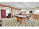 Finished basement area features game table, wood beams, and custom lighting at 387 Pine Dr, Idaho Springs, CO 80452