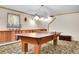 Finished basement with a large ping pong table and custom shelving units at 387 Pine Dr, Idaho Springs, CO 80452