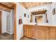 Well-lit bathroom with double sinks, wood cabinets, and a glass-enclosed shower at 387 Pine Dr, Idaho Springs, CO 80452