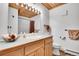 Bathroom with wood vanity, modern fixtures, and ample lighting at 387 Pine Dr, Idaho Springs, CO 80452