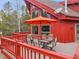 Outdoor deck with a patio table, chairs, and large umbrella perfect for entertaining guests and enjoying the forest view at 387 Pine Dr, Idaho Springs, CO 80452