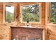 Cozy dining area featuring wood-paneled walls and views of the surrounding nature at 387 Pine Dr, Idaho Springs, CO 80452
