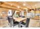 Dining room with wood table and seating for six adjacent to the kitchen at 387 Pine Dr, Idaho Springs, CO 80452