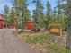 View of home with an outbuilding, moose sculpture, and swing at 387 Pine Dr, Idaho Springs, CO 80452