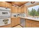 Bright kitchen features wood cabinets, stainless steel dishwasher, and natural light at 387 Pine Dr, Idaho Springs, CO 80452