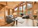 Open-concept living room with lots of natural light and stunning views of surrounding forest at 387 Pine Dr, Idaho Springs, CO 80452