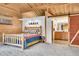 Spacious main bedroom with wood accents and an ensuite bathroom featuring a sliding barn door at 387 Pine Dr, Idaho Springs, CO 80452