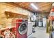 Utility room features a new washer and dryer unit, shelving, and water heater at 387 Pine Dr, Idaho Springs, CO 80452