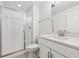 Bright bathroom featuring a sleek vanity, a large mirror, and a modern glass-enclosed shower at 660 Split Rock Dr, Erie, CO 80516