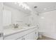 Bright bathroom featuring double sinks with white countertops and a large mirror at 660 Split Rock Dr, Erie, CO 80516