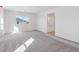 Bright living room featuring neutral walls and carpet, with natural light from large windows at 660 Split Rock Dr, Erie, CO 80516