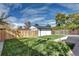 Spacious backyard with new fence, green grass and an outbuilding in the background at 3033 Leyden St, Denver, CO 80207