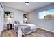 Comfortable bedroom featuring hardwood floors, a plush bed with decorative pillows, and natural light from the window at 3033 Leyden St, Denver, CO 80207