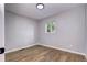 Bright bedroom with hardwood floors, neutral wall color, and a window allowing for natural light at 3033 Leyden St, Denver, CO 80207