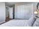 Cozy bedroom showcases a closet with sliding doors, fresh paint, and modern wood-look floors at 3033 Leyden St, Denver, CO 80207