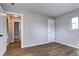 Neutral bedroom featuring new floors and ample natural light with a doorway view to the bathroom at 3033 Leyden St, Denver, CO 80207