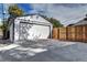 Large detached garage with a concrete drive, and wooden fence at 3033 Leyden St, Denver, CO 80207