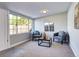 Inviting sunroom with large windows, two chairs, and a coffee table at 3033 Leyden St, Denver, CO 80207