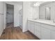 Modern bathroom featuring a double vanity and a glass-enclosed shower at 9061 Telluride Ct, Commerce City, CO 80022