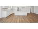 Bright kitchen island with seating and white cabinetry, offering ample counter space at 9061 Telluride Ct, Commerce City, CO 80022