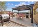 Backyard deck features a pergola, grill, and outdoor seating for entertaining at 6860 Krameria St, Commerce City, CO 80022