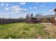 Large backyard with a deck, pergola, and mature trees providing ample shade at 6860 Krameria St, Commerce City, CO 80022