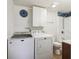 Bright bathroom featuring a shower/tub combo, toilet, and stacked washer and dryer at 6860 Krameria St, Commerce City, CO 80022