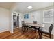 Well-lit dining area with hardwood floors, a modern table and chairs, and easy access to the kitchen at 6860 Krameria St, Commerce City, CO 80022