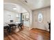 Bright dining room with hardwood floors, modern table and chairs, and ample natural light at 6860 Krameria St, Commerce City, CO 80022