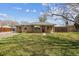 Charming brick ranch-style home with a well-maintained front yard and inviting curb appeal on a sunny day at 6860 Krameria St, Commerce City, CO 80022